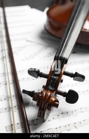 Classic violin, bow on note sheets, closeup Stock Photo