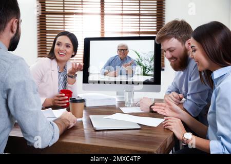 Group of colleagues using video chat for online job interview in office Stock Photo