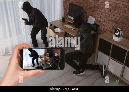 Man monitoring situation at his house with CCTV app on smartphone, closeup. Thieves stealing money Stock Photo