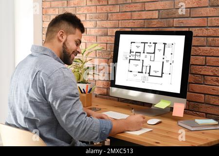 Architect making project of house house on computer in office Stock Photo