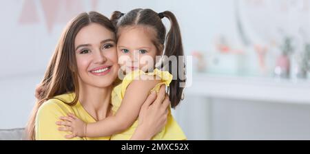 Young mother with little daughter at home. Banner design Stock Photo