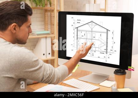 Architect making project of house on computer in office Stock Photo