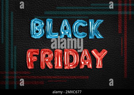 Phrase BLACK FRIDAY made of foil balloon letters on dark background Stock Photo