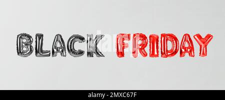 Phrase BLACK FRIDAY made of foil balloon letters on white background. Banner design Stock Photo