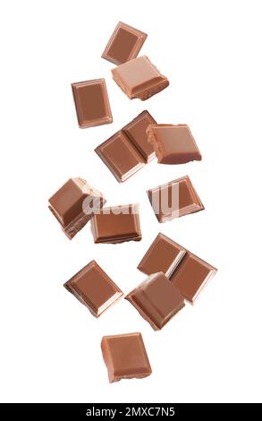 Delicious milk chocolate pieces falling on white background Stock Photo