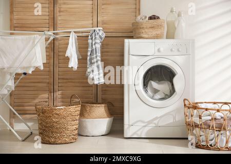 Modern washing machine in laundry room interior Stock Photo
