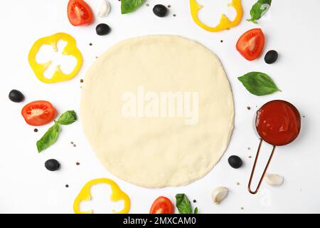 Flat lay composition with dough and fresh ingredients for pizza on white background Stock Photo