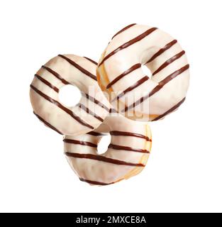 Set of falling delicious donuts on white background Stock Photo