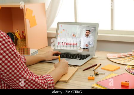 Young woman using laptop for online studying at home, closeup Stock Photo