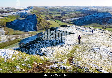 Walking down Chrome Hill along the Dragon's Back ridge towards the prominent peak of  Parkhouse Hill in the Derbyshire Peak District UK Stock Photo