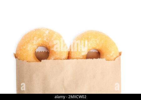 Delicious donuts in paper bag on white background, top view Stock Photo