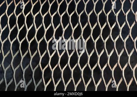 Background from a metal brilliant lattice on a black background. Stock Photo