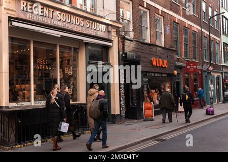 London, UK. 30th January, 2023. Members of the public pass Regent Sounds Studio in Denmark Street. The studio, which is now a guitar shop, operated between 1951 and the early 1980s, playing host to The Rolling Stones, The Jimi Hendrix Experience, The Kinks, The Who, Black Sabbath, The Bee Gees, Tom Jones and The Yardbirds among others. Denmark Street is currently experiencing considerable redevelopment as a result of Crossrail. Credit: Mark Kerrison/Alamy Live News Stock Photo