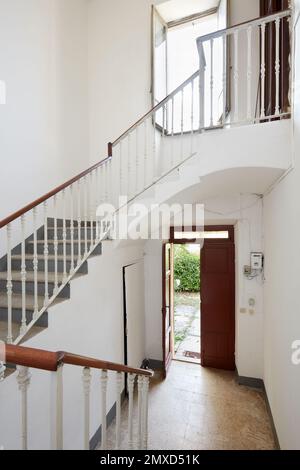 Staircase with white walls in old country house Stock Photo