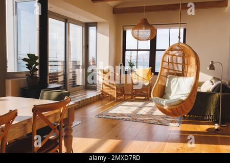 General view of luxury living room interior with armchairs, sofa and hanging basket chair Stock Photo