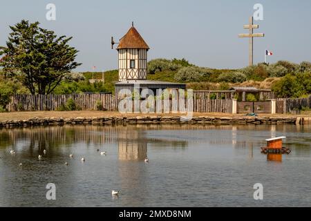 Peaceful lake and cross of war (croix de lorraine) at Courseulles-sur-Mer at Normandy's landing beaches, France Stock Photo