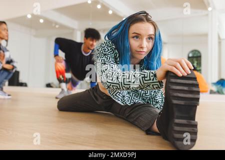 Image of caucasian female hip hop dancer practicing at dance studio. Dance, rhythm, movement and training concept. Stock Photo