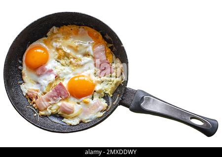 Image of scrambled eggs with bacon and onions in an old frying pan Stock Photo