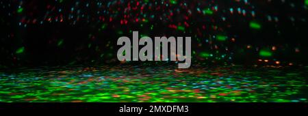 blurred rays of light on the disco floor. red green blue neon searchlight lights. laser lines and lighting effect. night empty stage in studio with ne Stock Photo