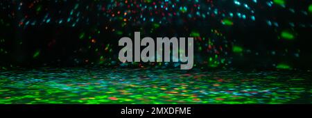 blurred rays of light on the disco floor. red green blue neon searchlight lights. laser lines and lighting effect. night empty stage in studio with ne Stock Photo