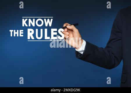 Businessman using virtual screen with phrase Know the rules, closeup Stock Photo