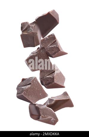 Delicious chocolate chunks falling on white background Stock Photo