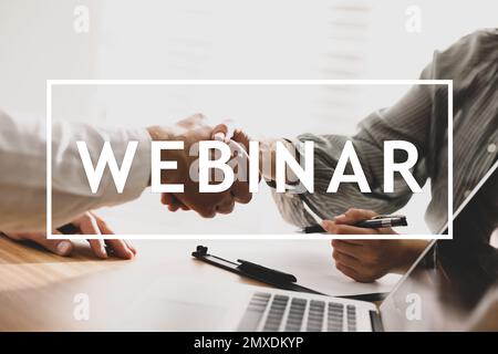 People shaking hands in office, closeup. Business webinar Stock Photo