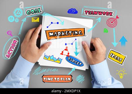 Strategic planning concept. Scheme and man with sheets of paper on grey background, top view Stock Photo