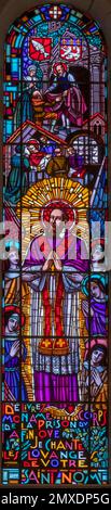 ANNECY, FRANCE - JULY 11, 2022: The St. Francis de Sale on the stained glass of Basilique de la Visitation church designed by Ch. Plessard Stock Photo