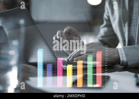 Forex trading. Man working with laptop in office and chart, closeup Stock Photo