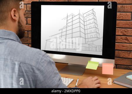 Architect making project of house on computer in office, closeup Stock Photo