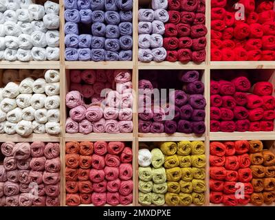 A shelf in a store full of colorful balls of yarn. Stock Photo