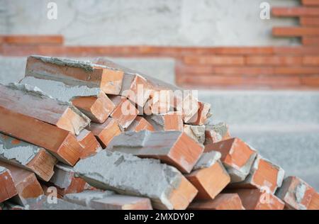 orange brown old brickwork stack off wall panel under construction exterior with empty space blurred background.structure material house renovation ba Stock Photo