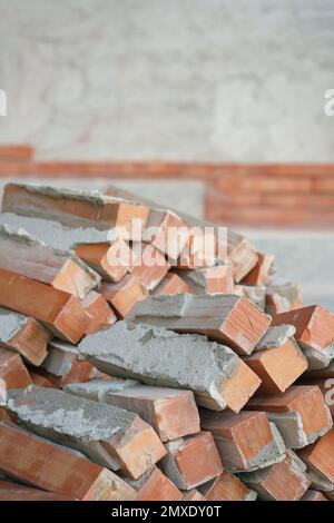 orange brown old brickwork stack off wall panel under construction exterior with empty space blurred background.structure material house renovation ba Stock Photo