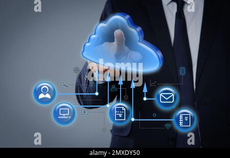 Modern storage technology concept. Man touching icon of cloud on virtual screen Stock Photo