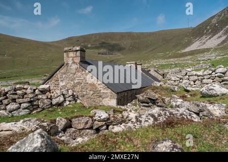 Restored 19th century stone cottages and blackhouse ruins in the old village on Hirta, the main island of St Kilda, Scotland. Stock Photo