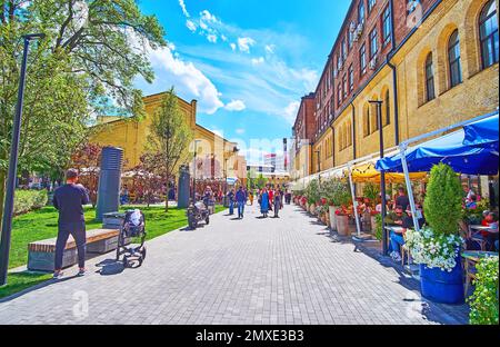 KYIV, UKRAINE - MAY 23, 2021: The old Arsenal Plant was converted into a modern business center with a large pedestrian zone, Kyiv Food Market, alley Stock Photo