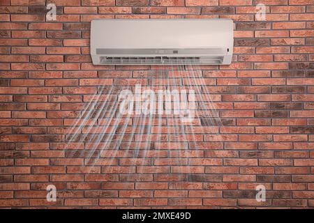 Modern air conditioner on brick wall indoors Stock Photo