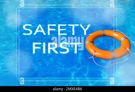 Safety first. Life buoy in swimming pool with clean blue water Stock Photo