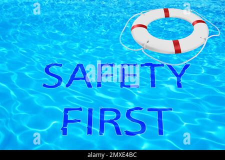 Safety first. Life buoy in swimming pool with clean blue water Stock Photo