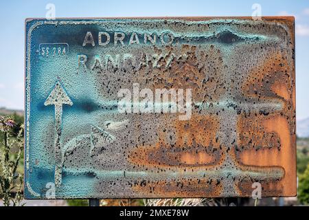 A badly rusted road sign on the slopes of Mount Etna, Sicily, Italy, resembling an artwork Stock Photo