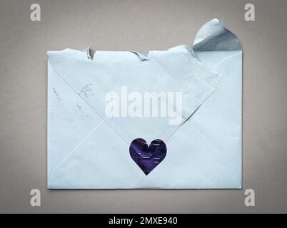 Torn (opened) envelope on a grey background Stock Photo