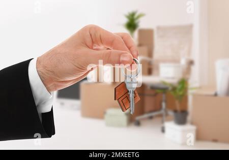 Man with key in new modern apartment, closeup Stock Photo