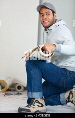 industrial tiler builder worker installing floor Stock Photo