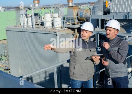 engineering workers in discussion on site Stock Photo
