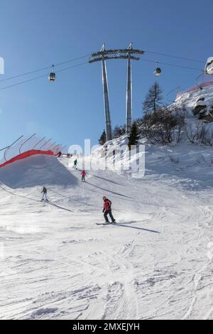 Slopes and skiers below the top station of the 5 laghi cable car, MADONNA DI CAMPIGLIO. Stock Photo