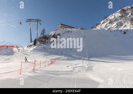 Slopes and skiers below the top station of the 5 laghi cable car, MADONNA DI CAMPIGLIO. Stock Photo