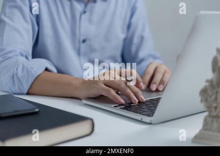 Businessperson hands working and typing on laptop keyboard on table. Stock Photo