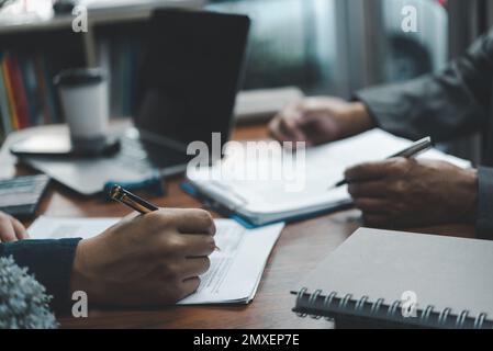 businessman hand putting personal signature on contract document. Stock Photo