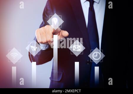 Core values concept. Businessman pointing at icon on virtual screen Stock Photo